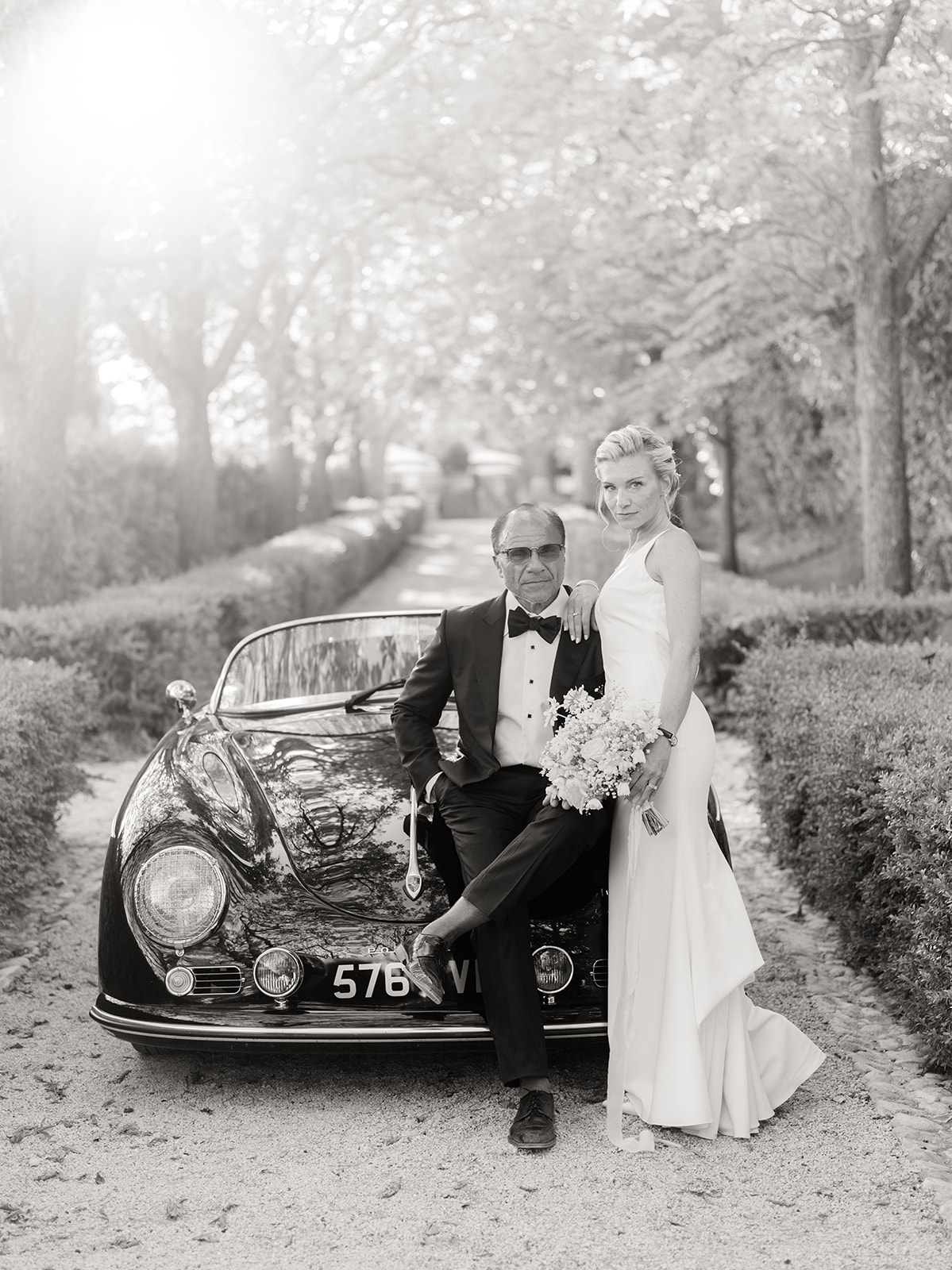 bride and groom on the car